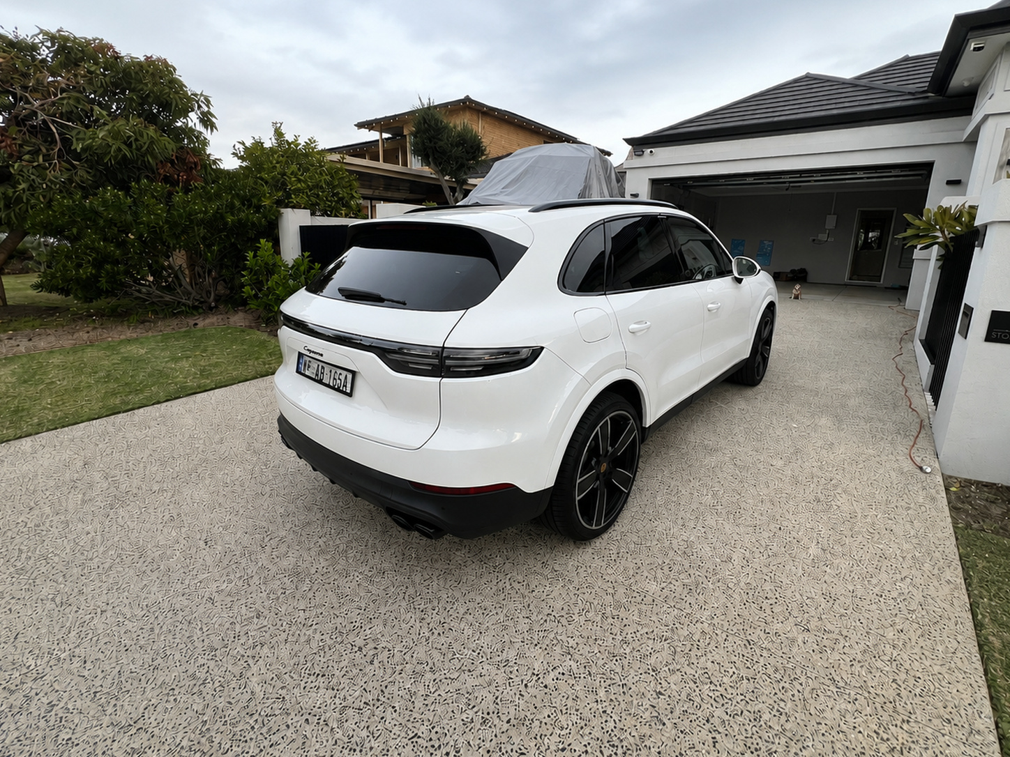 Freshly detailed white Porsche Cayenne on a Perth driveway after a mobile detail